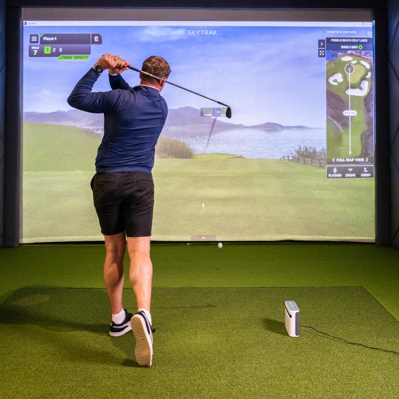 SkyTrak+ SIG8 golf simulator in use
